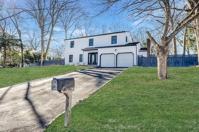 view of front property featuring a garage and a front yard