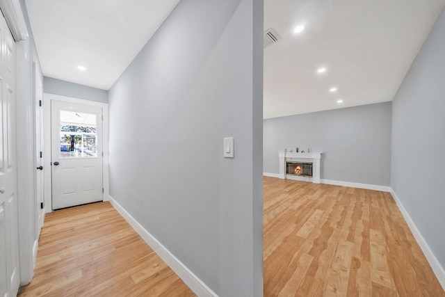 corridor with light hardwood / wood-style flooring