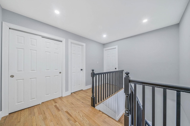 corridor with light hardwood / wood-style floors