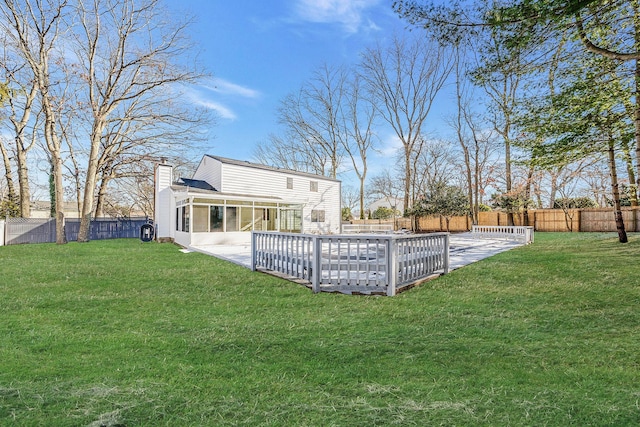 view of yard featuring a patio, a sunroom, and a swimming pool