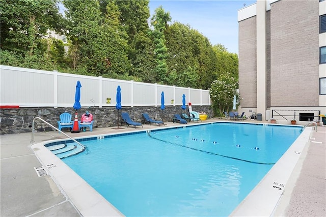 view of swimming pool featuring a patio area