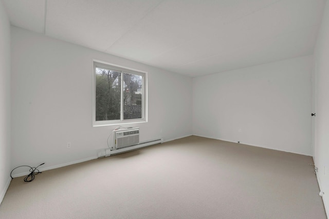 carpeted empty room featuring baseboard heating