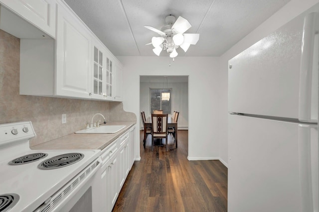 kitchen with dark hardwood / wood-style floors, white cabinetry, sink, decorative backsplash, and white appliances