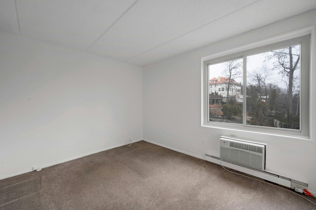 unfurnished room featuring a baseboard radiator and carpet