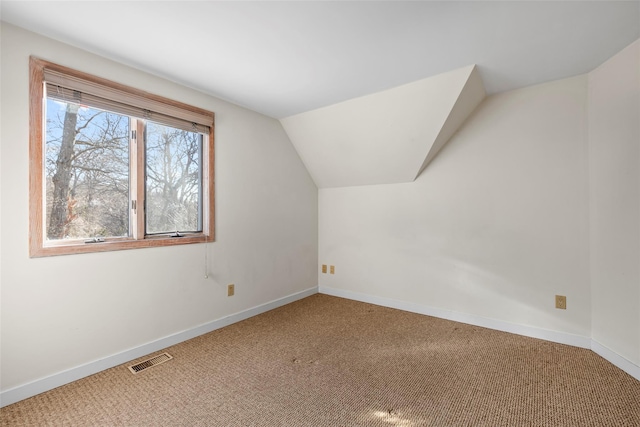 bonus room featuring vaulted ceiling and carpet flooring