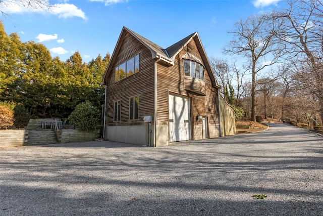 view of side of home featuring a garage