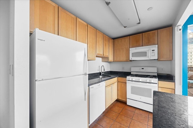 kitchen with white appliances, tile patterned flooring, and sink