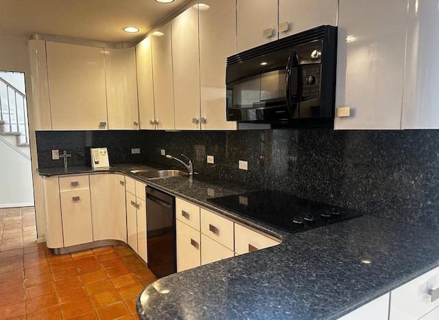 kitchen featuring sink, white cabinets, decorative backsplash, light tile patterned floors, and black appliances