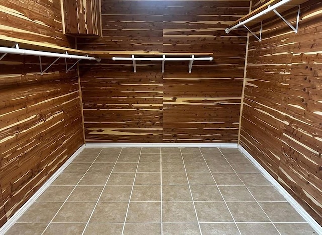 walk in closet featuring dark tile patterned flooring