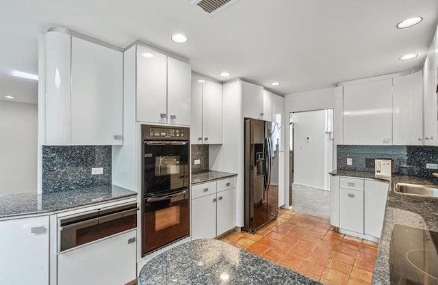 kitchen featuring white cabinetry, double oven, stainless steel fridge, and cooktop