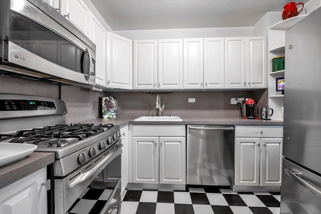 kitchen with appliances with stainless steel finishes, sink, and white cabinets