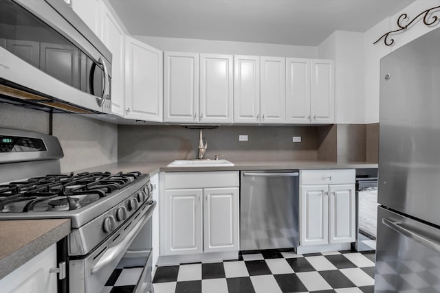 kitchen with white cabinetry, sink, decorative backsplash, and appliances with stainless steel finishes