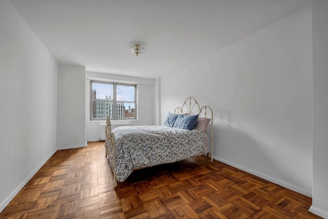 bedroom with dark parquet floors