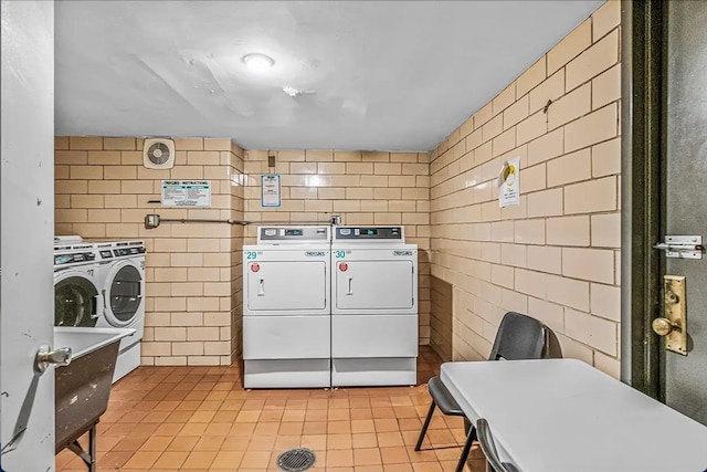 clothes washing area with separate washer and dryer