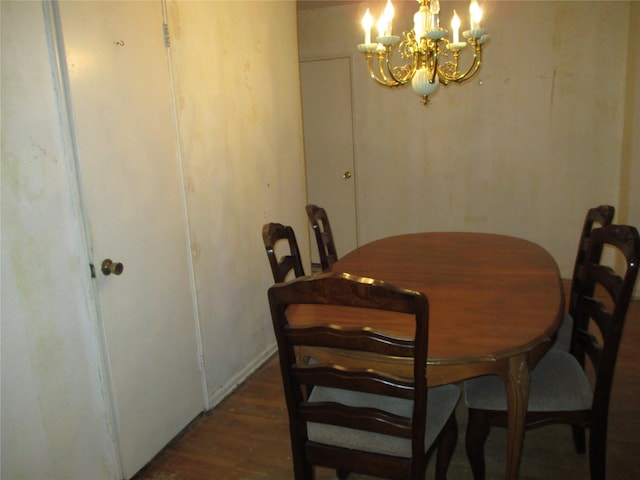 dining room with dark hardwood / wood-style flooring and a notable chandelier