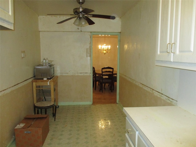 hall featuring a notable chandelier