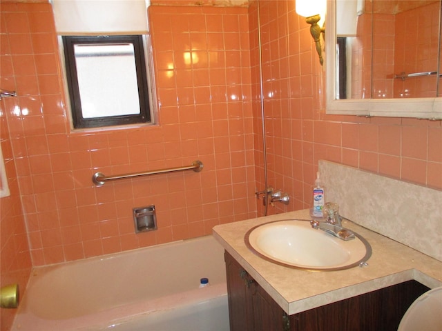 bathroom with vanity and tiled shower / bath combo