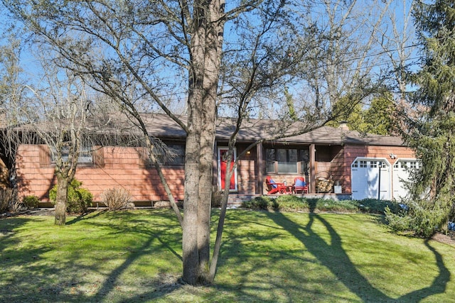 view of front of property featuring a garage and a front lawn