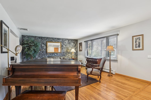 miscellaneous room with hardwood / wood-style flooring and a baseboard heating unit