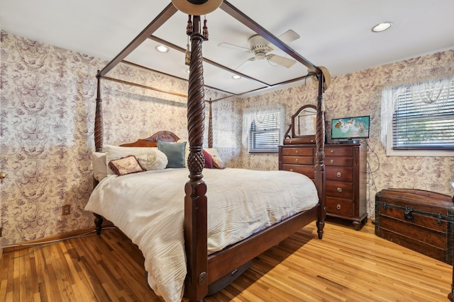 bedroom featuring multiple windows, wood-type flooring, and ceiling fan