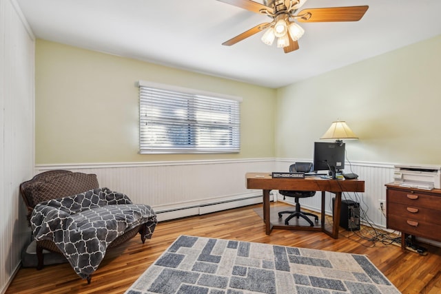 home office featuring hardwood / wood-style flooring, a baseboard radiator, and ceiling fan