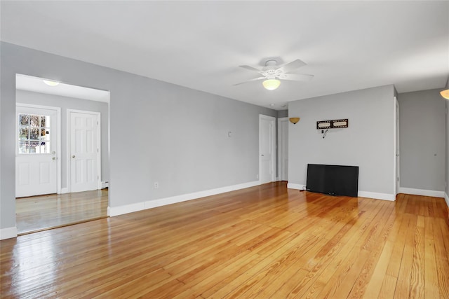 unfurnished living room featuring hardwood / wood-style flooring and ceiling fan