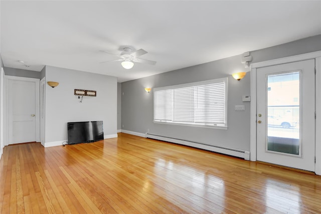 unfurnished living room featuring a baseboard radiator, ceiling fan, and light hardwood / wood-style floors