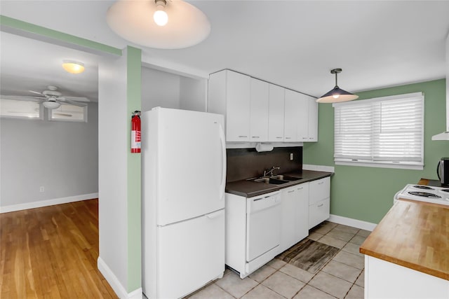 kitchen featuring tasteful backsplash, sink, white appliances, and white cabinets