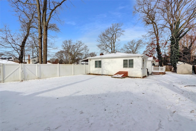 snow covered property with a deck