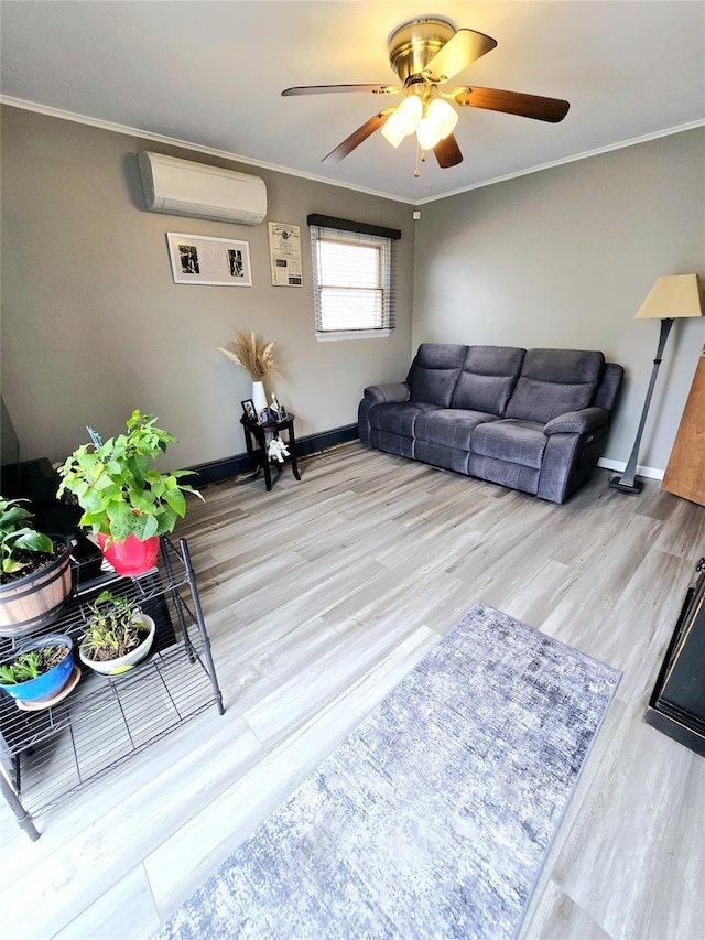 living room with a wall mounted air conditioner, ornamental molding, light hardwood / wood-style floors, and ceiling fan