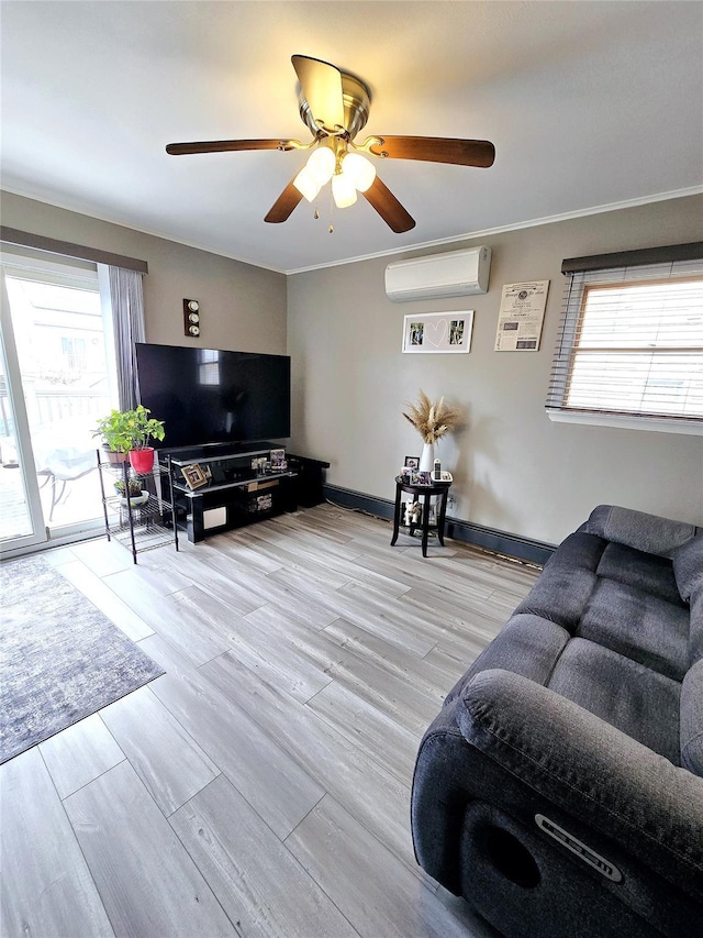 living room with a wealth of natural light, a wall unit AC, and light hardwood / wood-style floors