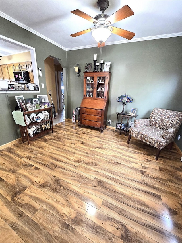 sitting room with crown molding, ceiling fan, and light hardwood / wood-style flooring