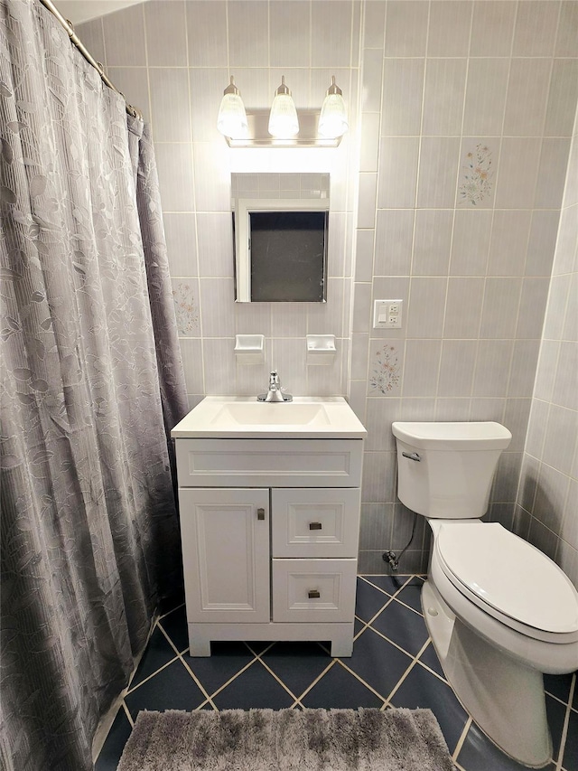 bathroom with tile patterned flooring and tile walls