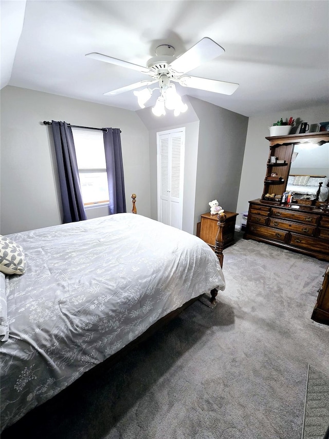 bedroom with lofted ceiling, carpet floors, a closet, and ceiling fan