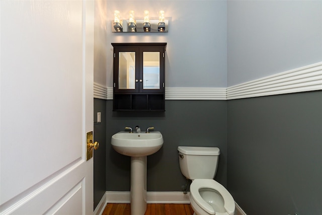 bathroom featuring sink, hardwood / wood-style floors, and toilet