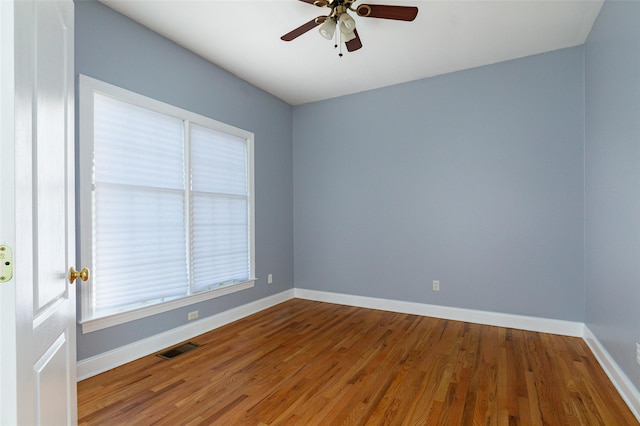 spare room with hardwood / wood-style floors and ceiling fan