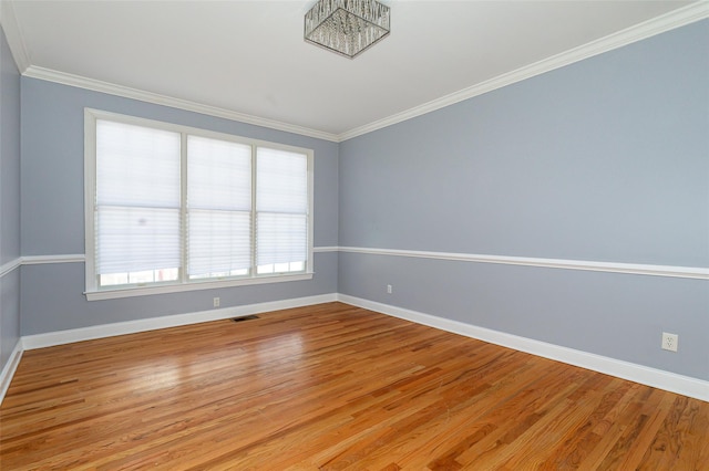 unfurnished room with ornamental molding and light hardwood / wood-style flooring