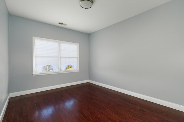 spare room with wood-type flooring