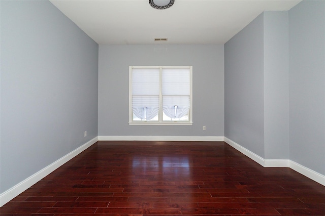 empty room featuring dark wood-type flooring