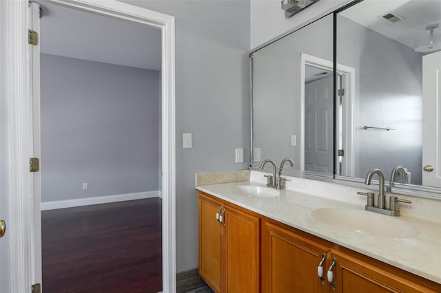 bathroom with hardwood / wood-style flooring and vanity