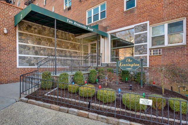 exterior space featuring stone siding and brick siding