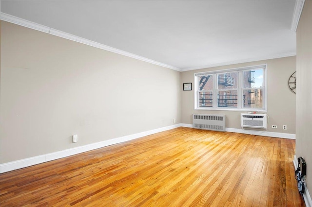 unfurnished living room with baseboards, radiator heating unit, light wood-style flooring, ornamental molding, and a wall mounted AC