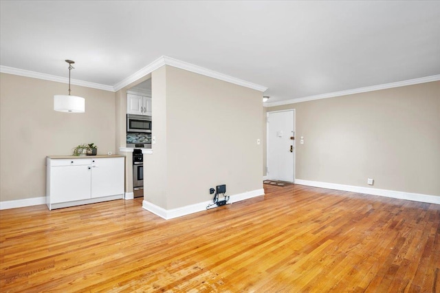 interior space featuring light wood-type flooring, crown molding, and baseboards