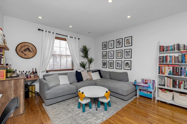 living room featuring hardwood / wood-style floors and bar area