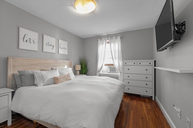 bedroom with cooling unit and dark wood-type flooring