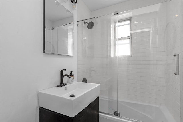 bathroom featuring vanity and shower / bath combination with glass door