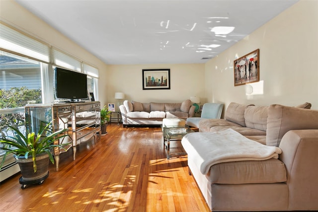 living area featuring visible vents and hardwood / wood-style floors