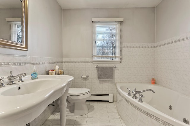 bathroom featuring toilet, a baseboard radiator, a whirlpool tub, tile patterned flooring, and a sink