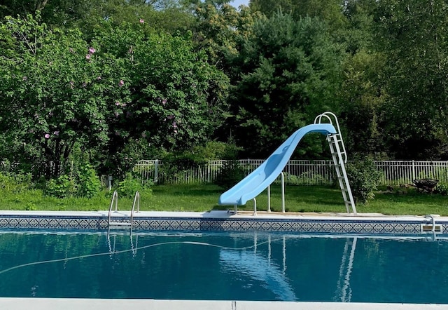 view of pool featuring a fenced in pool, fence, and a water slide