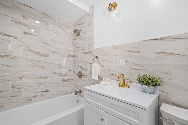 bathroom with tub / shower combination, toilet, tile walls, and vanity